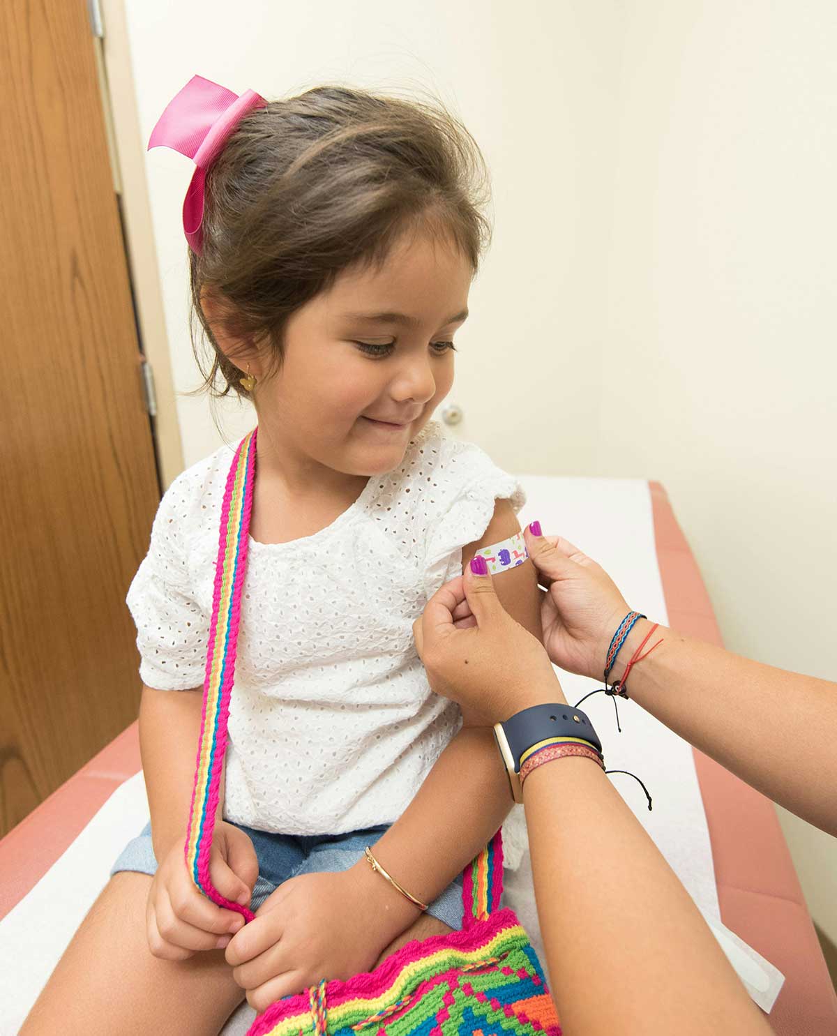 Young girl at doctor's office getting a bandaid